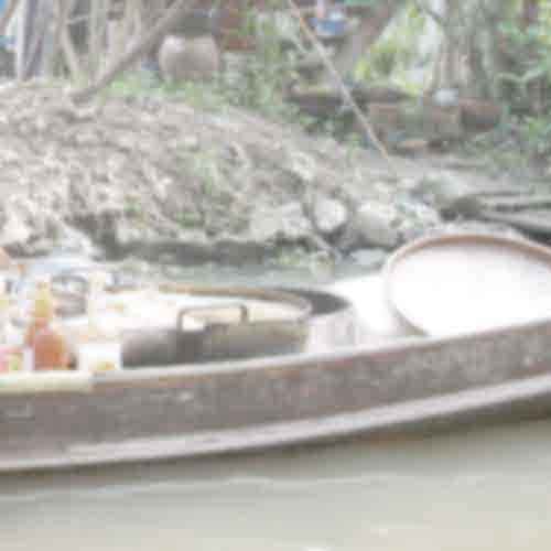 Vendor's boat with cooking pots and utensils on a canal - representing the culinary inspiration for private chefs